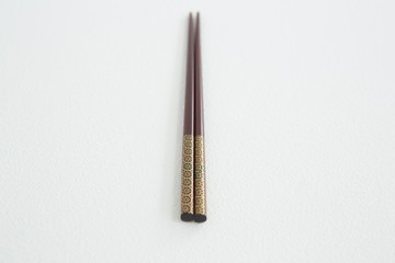 Brown chopsticks on white background