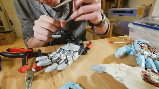 Crafting robotic bionic arm made on 3D printer. 4K.