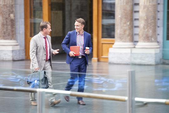 Businessmen walking outside the office