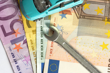 Ein Auto, Geld und Werkzeug eines Mechanikers