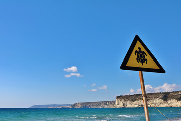 Traffic sign for turtles on a Mediterranean beach