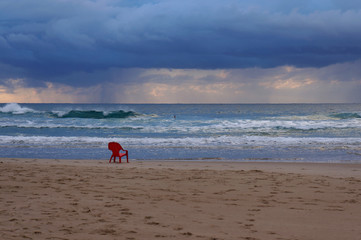 lone red chair on the beach