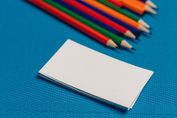multicolored pencils and business cards