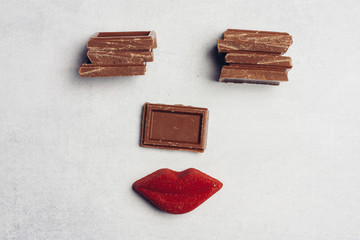 cubes with chocolate and red lips, a face made of sweets, sweets
