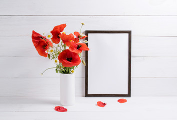Poppies in vase and motivational frame 