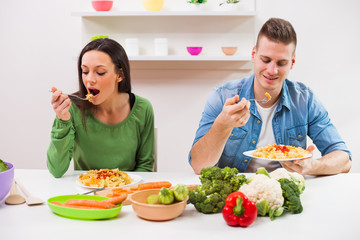 Young couple cooking in their kitchen.