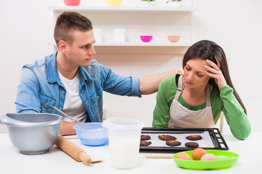 Young couple cooking in their kitchen.