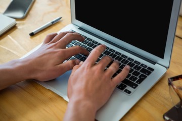 Business executive using laptop at desk