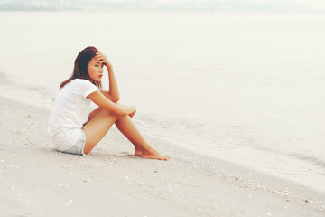 Fototapeta na wymiar Lonely Asian young female on the beach