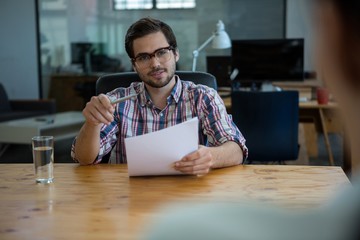 Business executive conducting job interview with woman