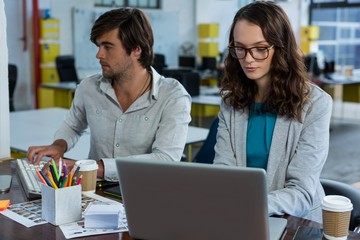 Fototapeta premium Graphic designers working at desk