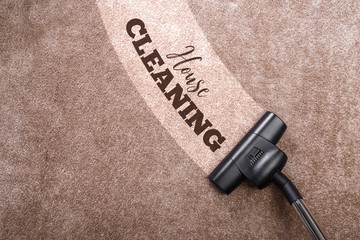 Vacuuming carpet with vacuum cleaner. House cleaning. Housework service. Close up of the head of a sweeper cleaning device.