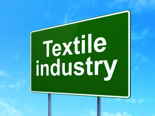 Manufacuring concept: Textile Industry on road sign background