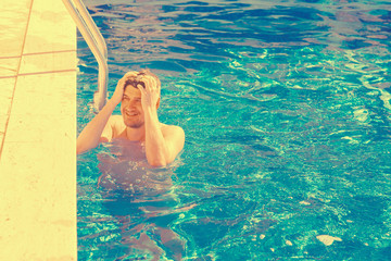 Handsome man near the edge of the pool