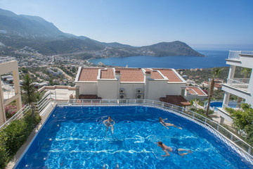 People swim in the rooftop pool
