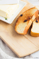 toast and butter on a white wooden background