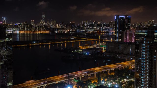 4k Timelapse Top View Of Hong Kong Modern Skyscrapers Night In Kowloon Bay with boats and vehicles in highway front the port -Dan