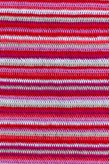 Crochet fabric in white and red colors with a stripes pattern