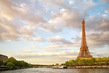 The Eiffel Tower and the river Seine at sunset sky background in Paris