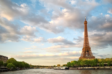 Fototapeta na wymiar The Eiffel Tower and the river Seine at sunset sky background in Paris