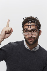 Man wearing many pairs of spectacles, portrait