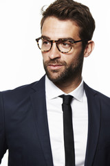 Seriously suited man in glasses, studio