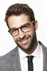 Smiling man in grey suit and glasses