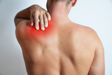 Concept of a pain in back shoulder of adult man with red highlighted problematic area, isolated on the white background