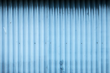 Blue metal wall of building. Grunge industry background with copy space.