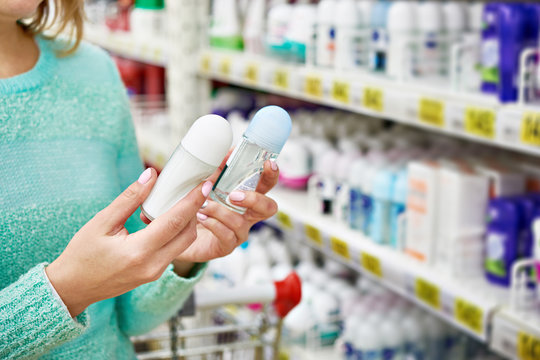Woman in shop chooses deodorant