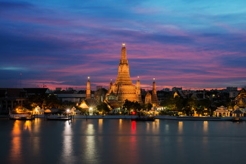 Obraz premium Wat Arun temple and Chao Phraya River at night in Bangkok, Thailand