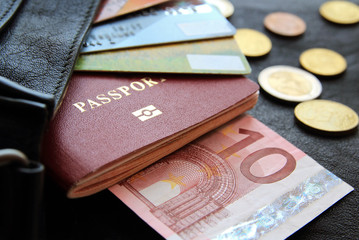 credit cards, passport, money, peeking out from the bag, closeup