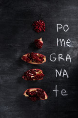 Pomegranate over dark chalkboard background