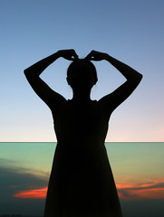 Close up Silhouette of woman expression Heart shape at sunset