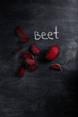 Cut beet over dark chalkboard background