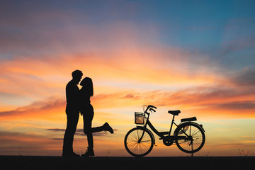 Fototapeta na wymiar Silhouette of couple in love kissing in sunset. Couple in love.