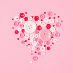 Valentine day concept, Heart shape of studs on pink paper background