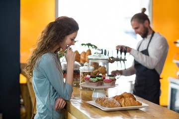 Smiling woman looking at croissant