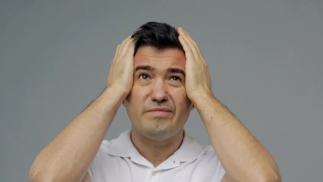 unhappy man suffering from head ache