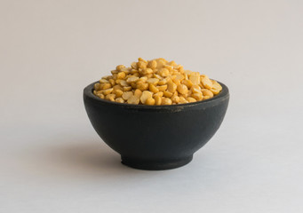 Heap of Dry Split Yellow Peas in Black Round Bowl