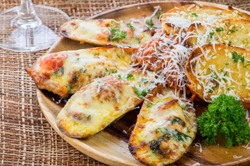 Mussels baked with cheese and garlic ,toasts with basil and garl