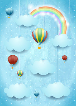 Surreal cloudscape with hot air balloons and rainbow