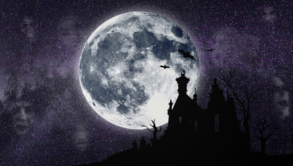Halloween. A silhouette of the old house against the background of the moon. Cemetery.