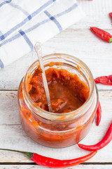 red sauce with chili on a white background top view