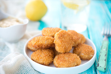 Home-made chicken nuggets on a wooden background
