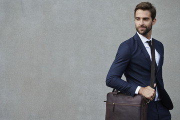 Businessman with bag, looking away