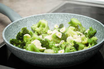 broccoli with garlic in a frying pan on the stove