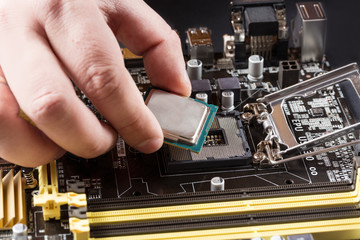CPU in hand before installation into the motherboard.