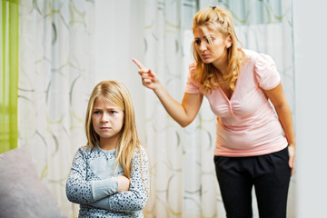 Mother and daughter having quarrel at home.