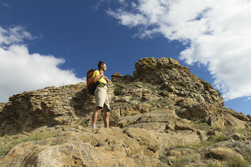 Fototapeta premium &nbsp;Hiking in the summer, young man with a backpack